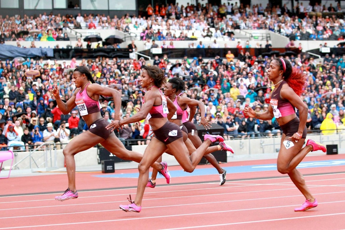 (L-R) Blessing Okagbare of Nigeria crosses the line ahead of Barbara Pierre of the United States in the Women's 100m Final during day two of the Sainsbury's Anniversary Games - IAAF Diamond League 2013 at The Queen Elizabeth Olympic Park on July 27, 2013 in London, England. (Photo by Harry Engels/Getty Images)
