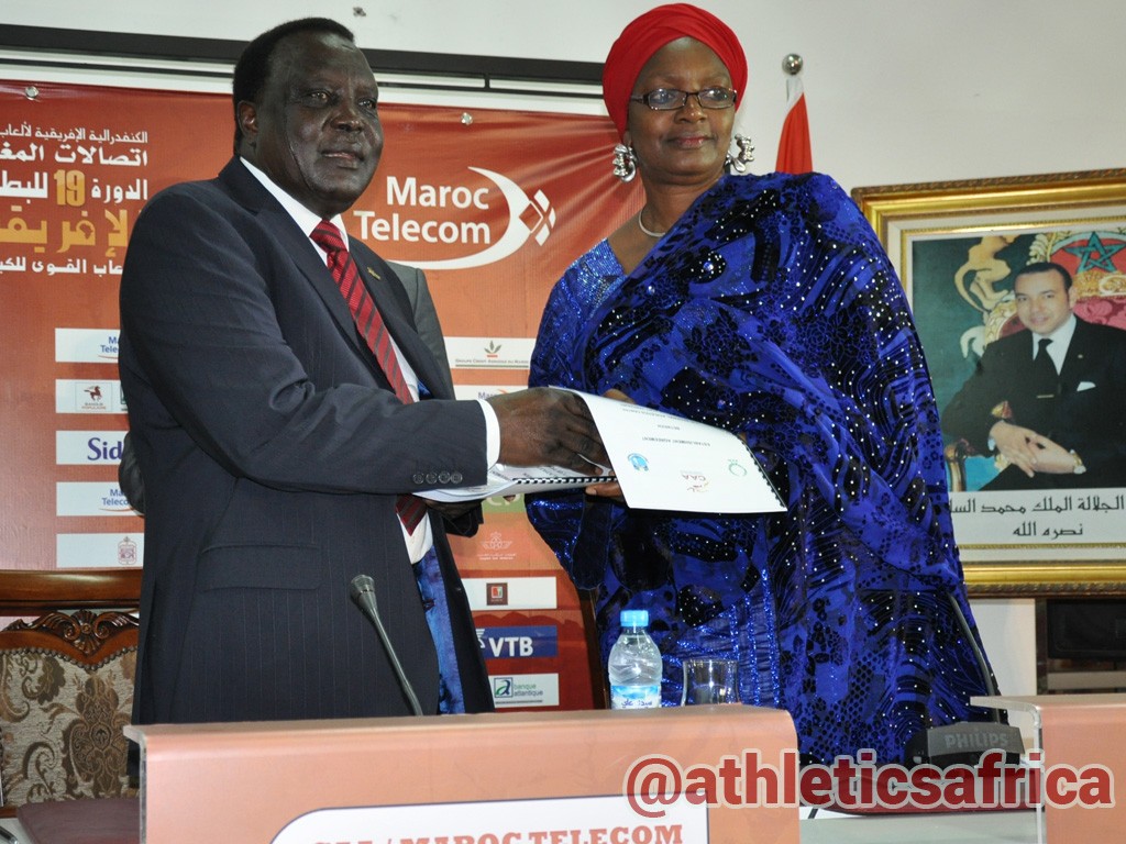 CAA President, Hamad Kalkaba Malboum presenting the signed Protocol agreement to Mrs Hauwa-Kulu Akinyemi, Director, Sports Planning Research and Documentation at the Nigerian Sports Commission, during the signing ceremony at the Grand Stade de Marrakech.