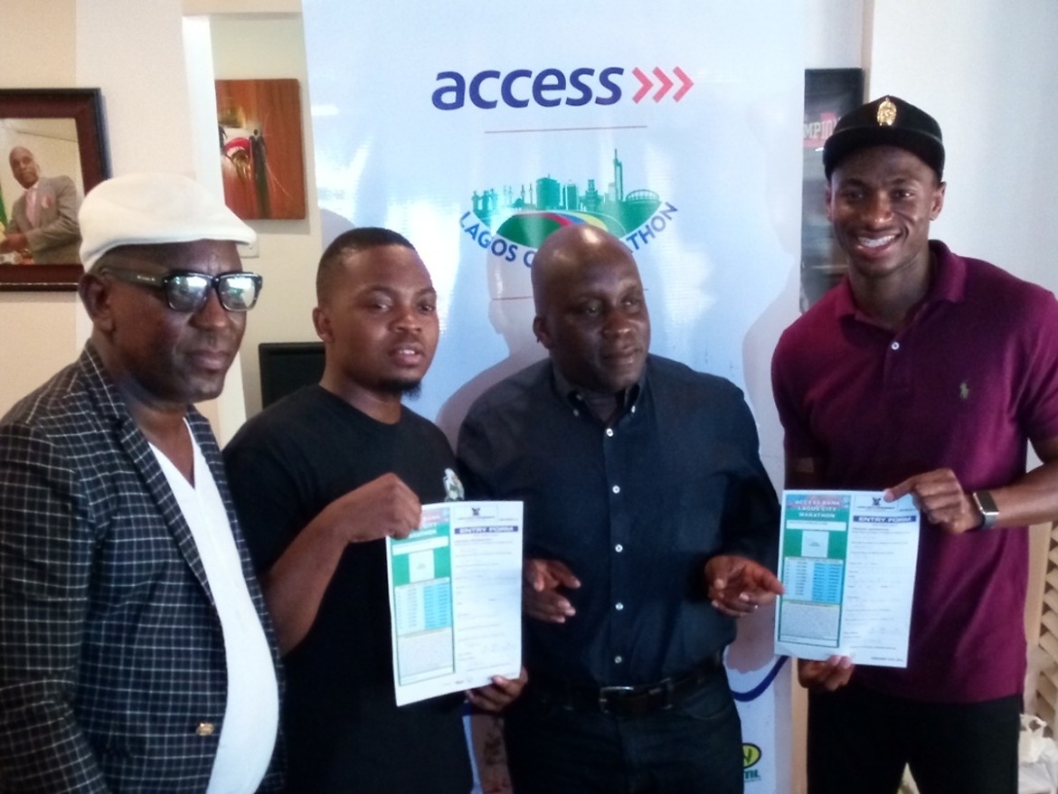 Olamide and Seye Ogunlewe with their race forms pose with head of the organising committee for the Access Bank Lagos City Marathon, Deji Tinubu / Photo: Lagos City Marathon