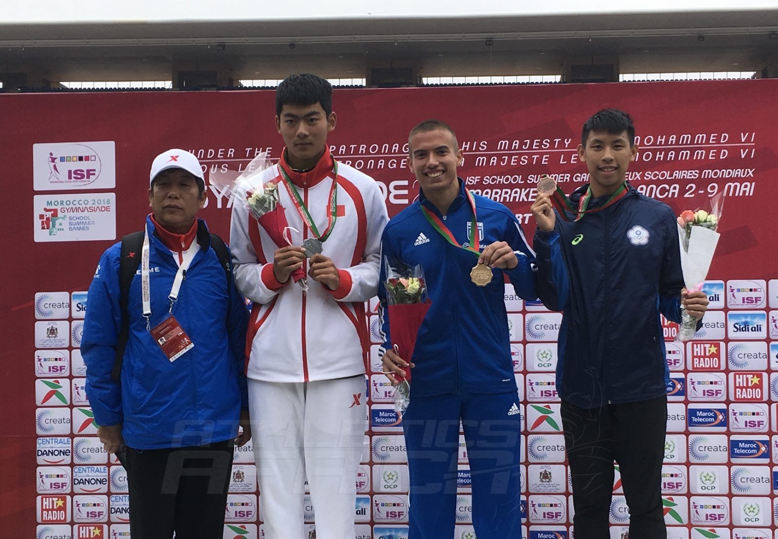 Ioannis Granitsiotis of Greece (C) flanked by Tai An of China and Yu-Sian Lin of Chinese Taipei on the podium after the Boys 100m medal presentation at Gymnasiade 2018 in Marrakech / Photo Credit: Yomi Omogbeja