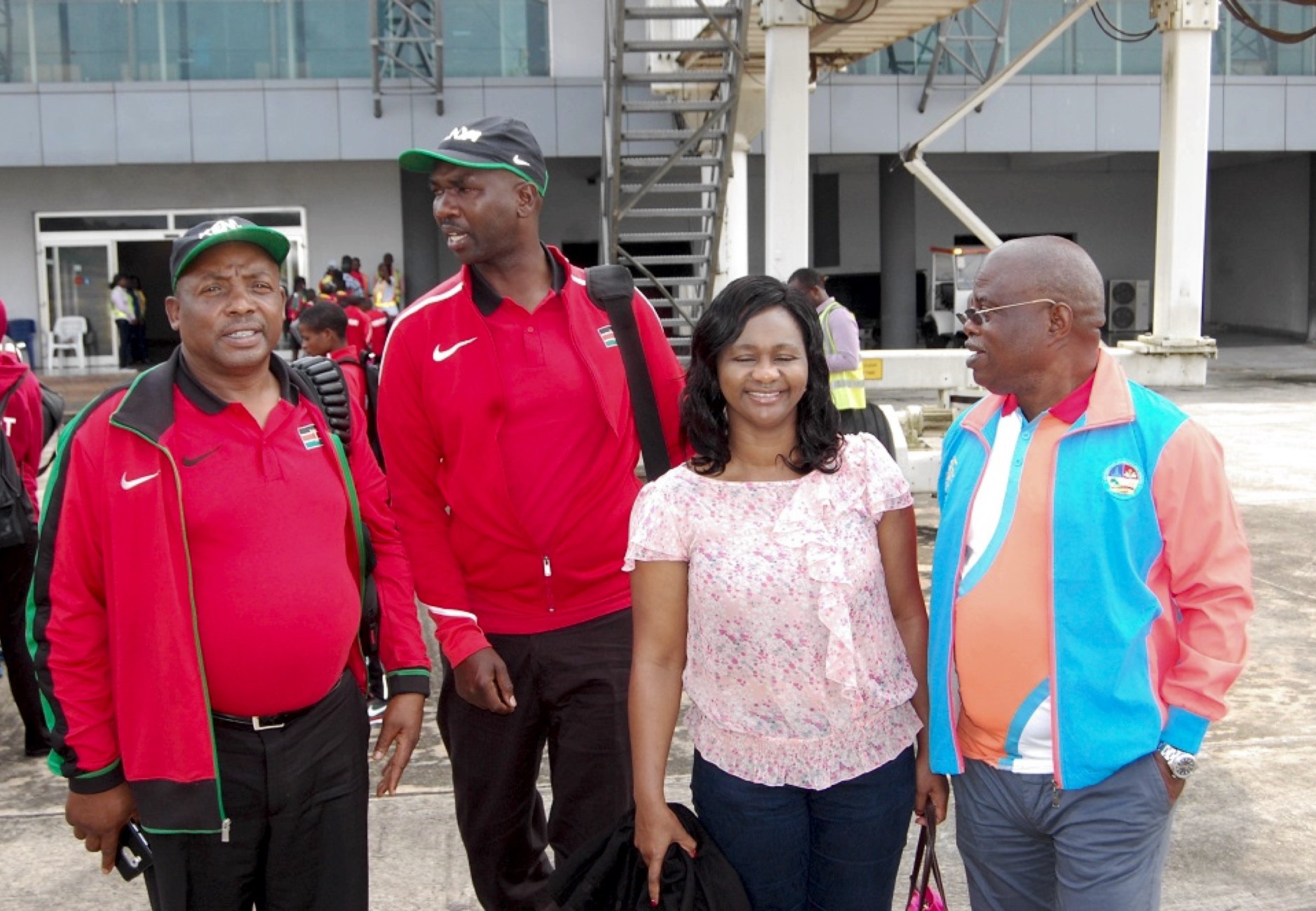 The Chair of the Asaba 2018 LOC, Chief Solomon Ogba, chats with officials of Athletics Kenya during the Kenyan team arrival at the Asaba International Airport for the 2018 African Senior Championships - 31 July, 2018. / Photo: LOC