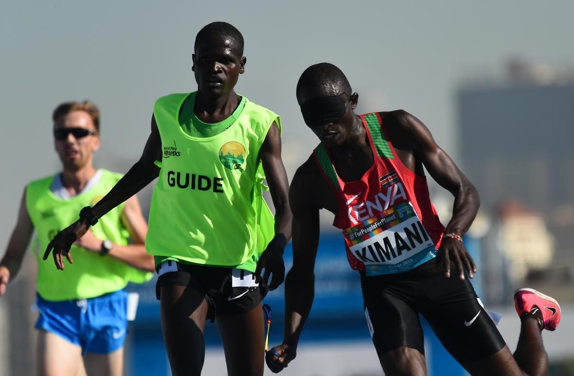 Samwel Kimani of Kenya and guide Boit James crosses the line to clinch gold in the Men's 5000m T11 final at Dubai 2019 World Para Athletics Championships. ?Getty Images