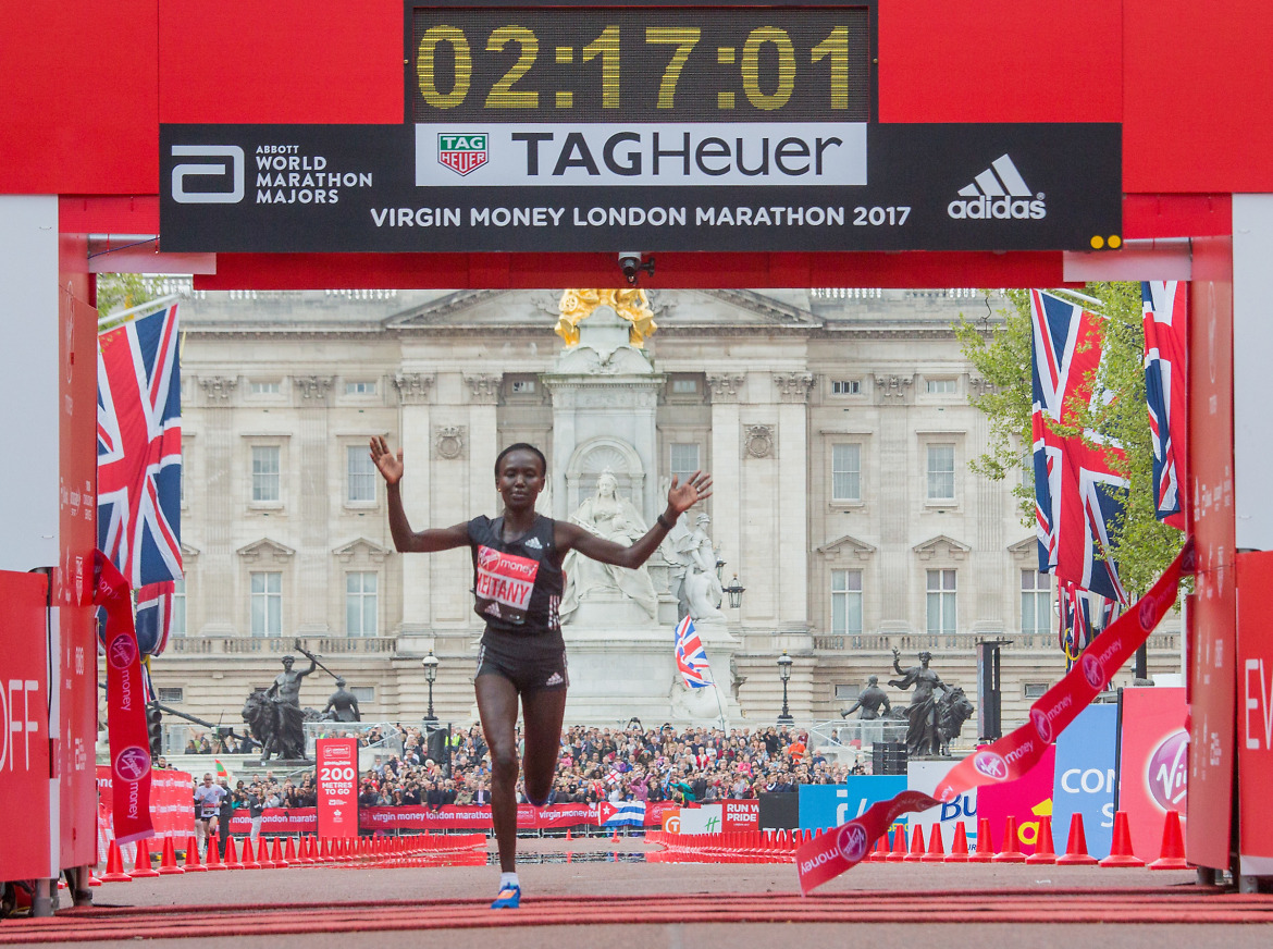 Mary Keitany KEN raises her arms as she crosses the finish line winning the elite women's race. The Virgin Money London Marathon, 23rd April 2017. credit: Roger Allen for Virgin Money London Marathon