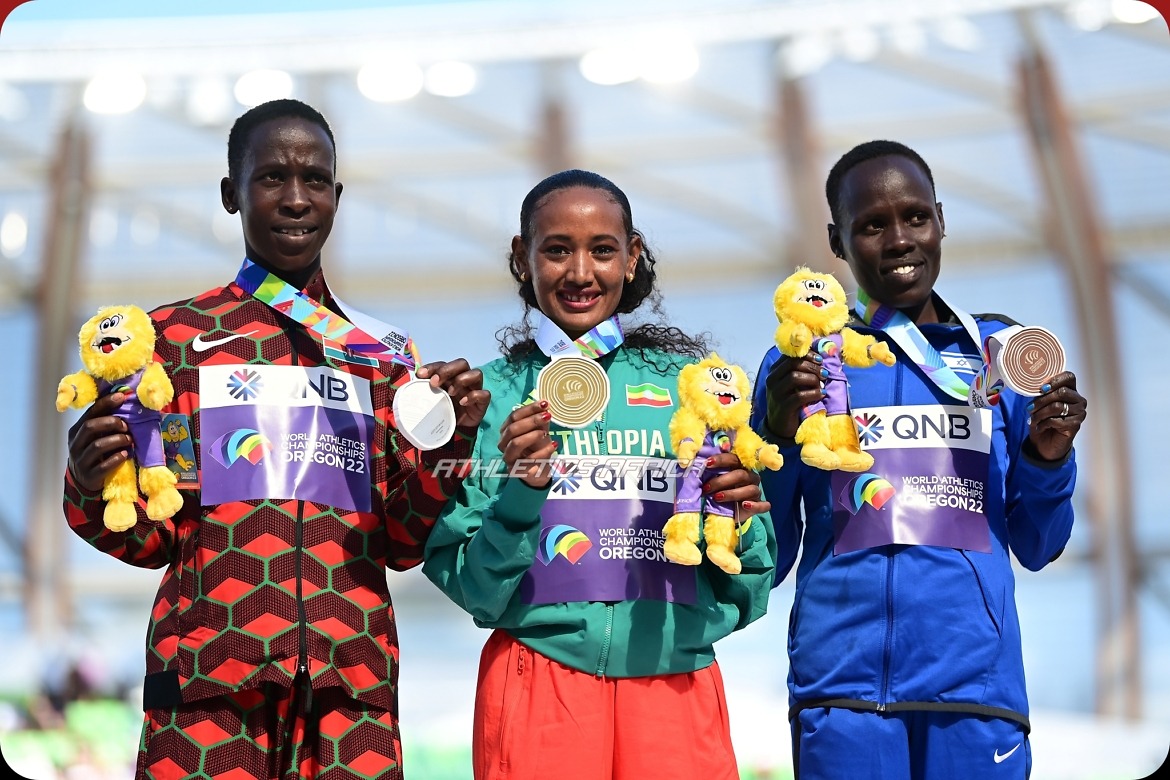 EUGENE, OREGON - JULY 18: Silver medalist Judith Jeptum Korir of Team Kenya, gold medalist Gotytom Gebreslase of Team Ethiopia, and bronze medalist Lonah Chemtai Salpeter of Team Israel pose during the medal ceremony for the Women's Marathon on day four of the World Athletics Championships Oregon22 at Hayward Field on July 18, 2022 in Eugene, Oregon. (Photo by Hannah Peters/Getty Images for World Athletics)