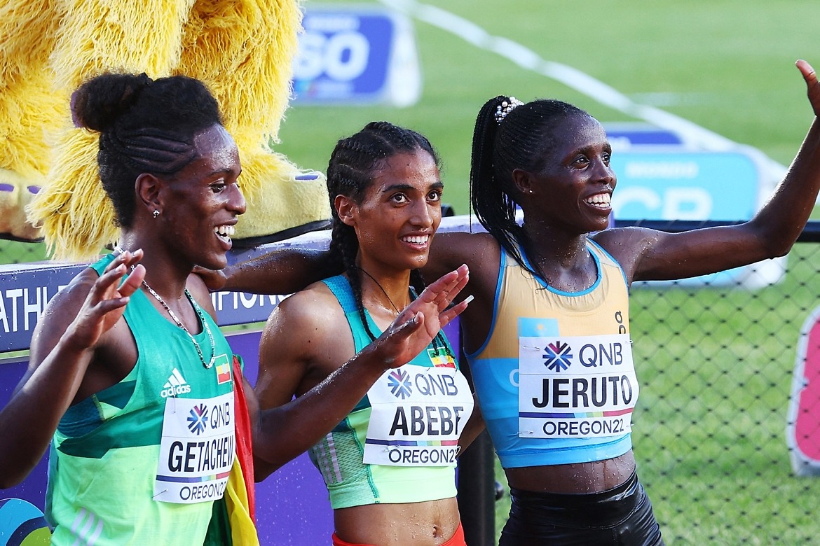Gold Medallist Kazakhstan's Norah Jeruto celebrates alongside Silver Medallist Ethopia's Werkuha Getachew and bronze medallist Ethopia's Mekides Abebe after winning the women's 3000 metres steeplechase and setting a new world championship record in Oregon / Reuters | Mike Segar
