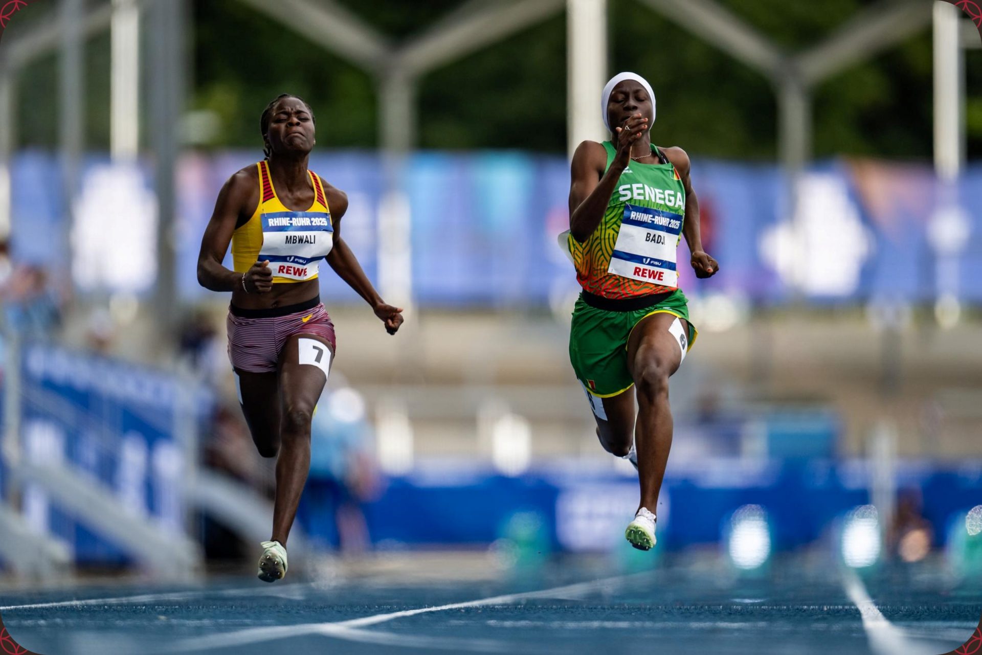 Bridget Mbwali of Uganda and Maimouna Badji of Senegal racing in the Women’s 100m Round 1 heats at the Rhine-Ruhr 2025 FISU Games in Bochum on Monday 21/07/2025 | Photo credit: Kevin Voigt / Rhine-Ruhr 2025