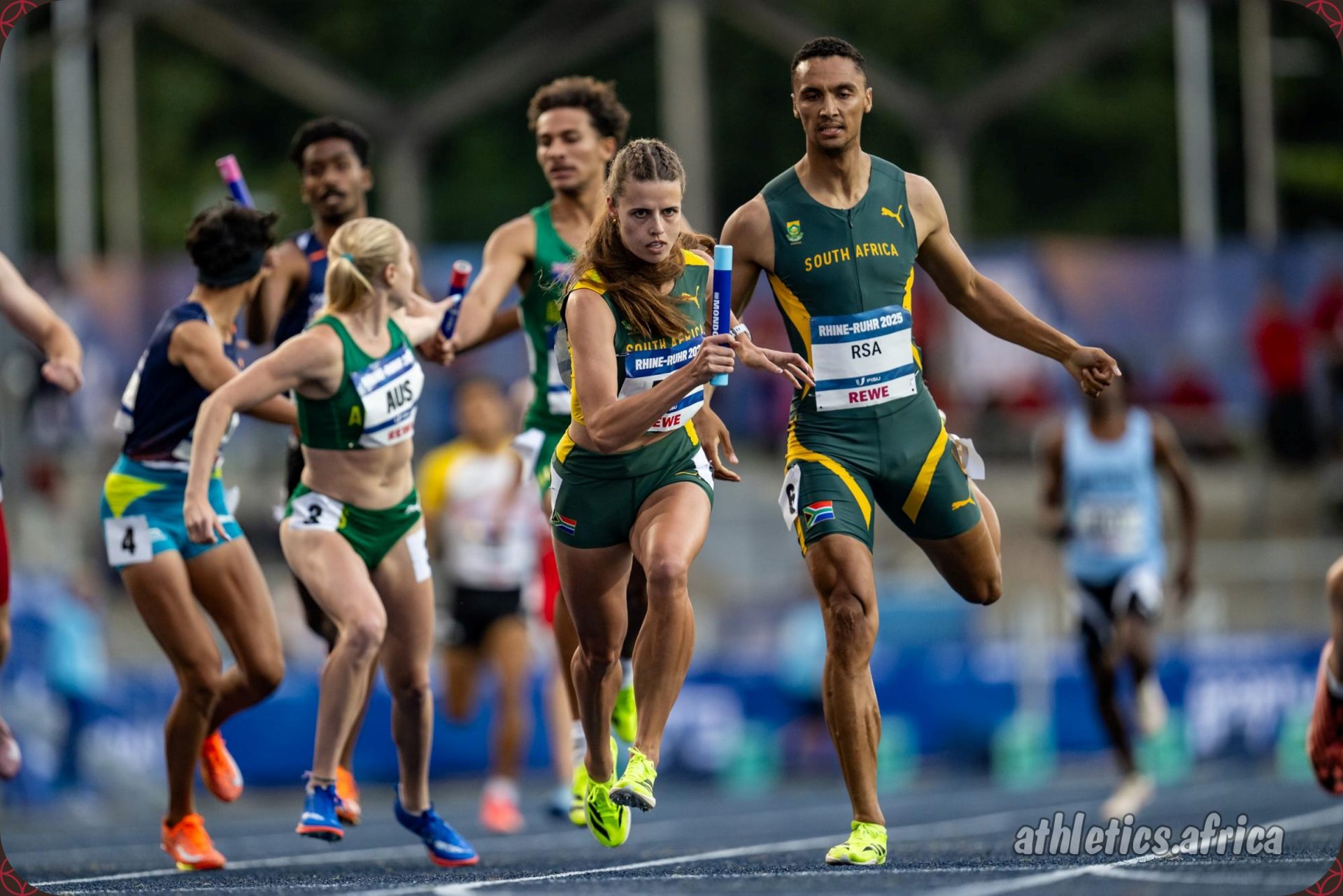 Baton exchange between Lythe Pillay and, anchor leg, Marlie Viljoen during the Mixed 4x400m Relay Final at the Rhine-Ruhr 2025 FISU Games in Bochum on Thursday 24/07/2025 | Photo credit: Kevin Voigt / Rhine-Ruhr 2025