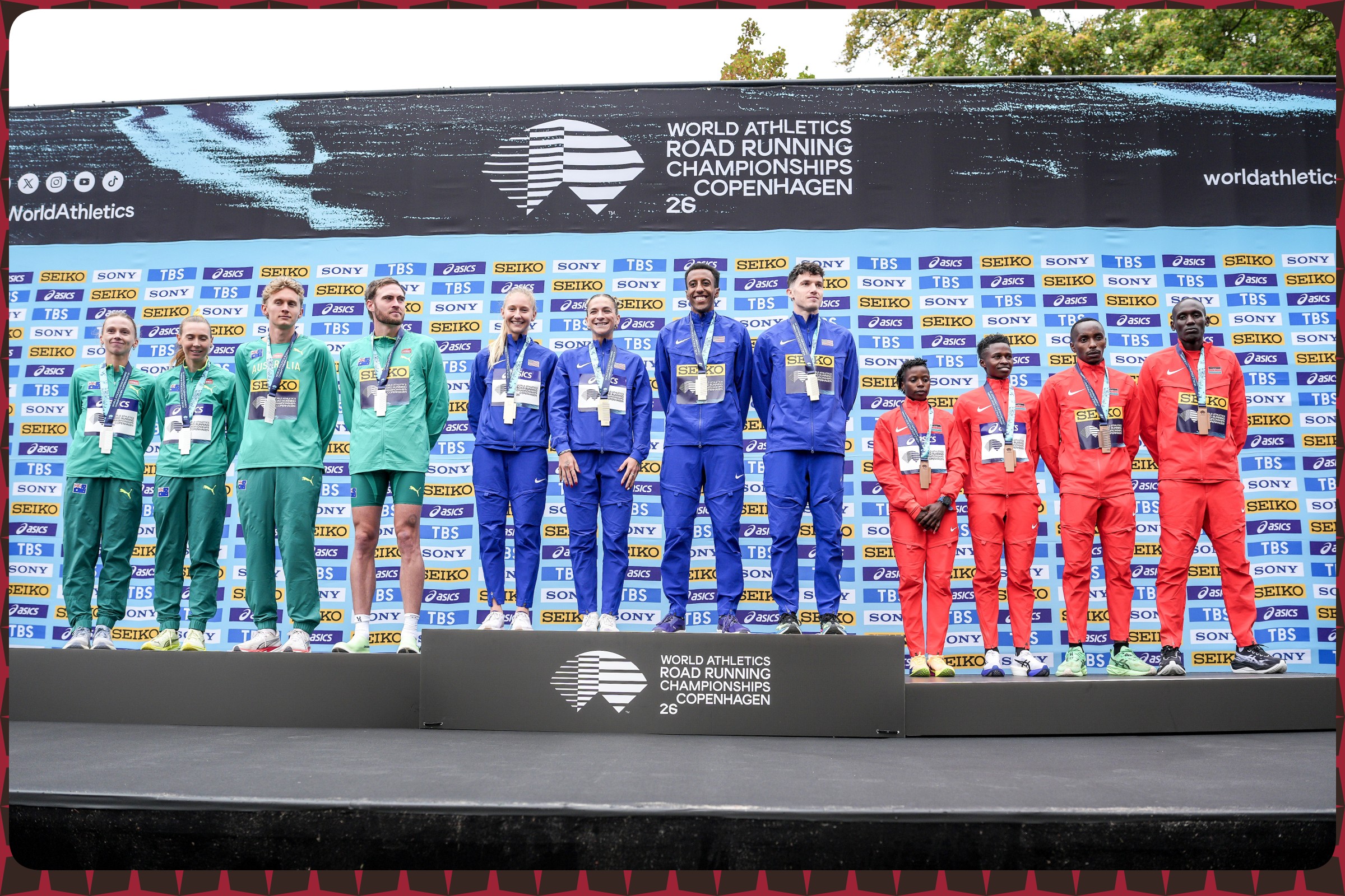 Members of Team Australia, Team United States and Team Kenya pose during the Mixed 5km medal ceremony at the World Athletics Road Running Championships on September 19, 2026 in Copenhagen, Denmark / Photo by Dan Vernon/World Athletics